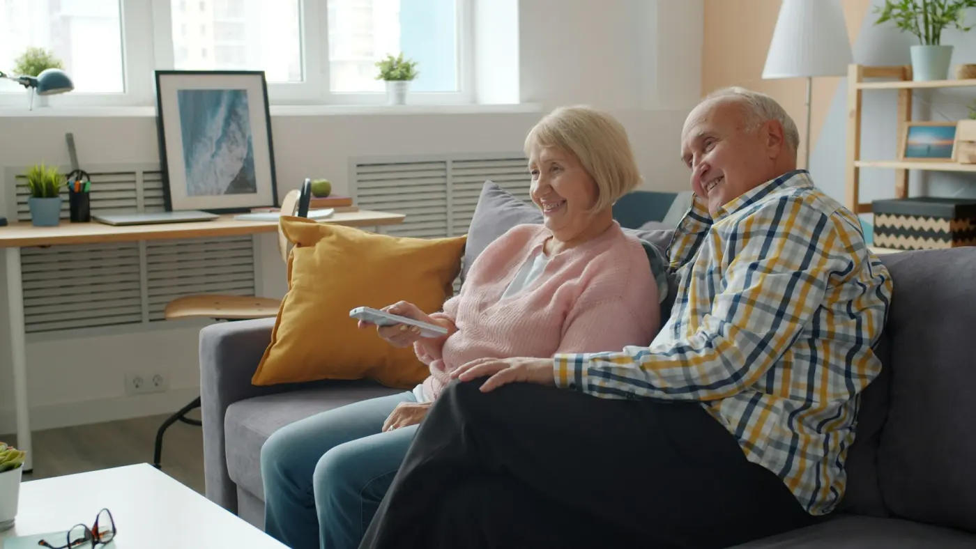 An older couple relaxing and chatting on the couch at home